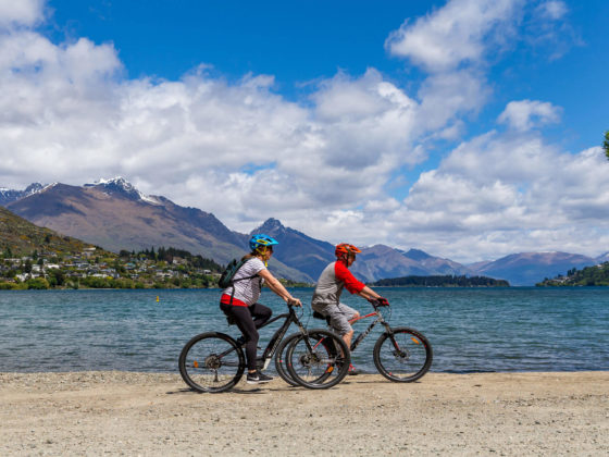 enjoying biking along the lake shore by Queenstown